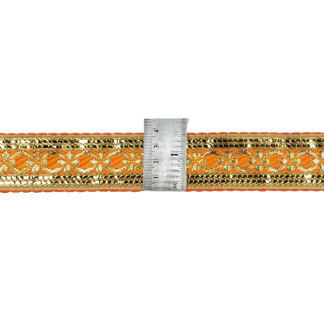 Decorative orange and gold trim with a ruler for scale on a white background