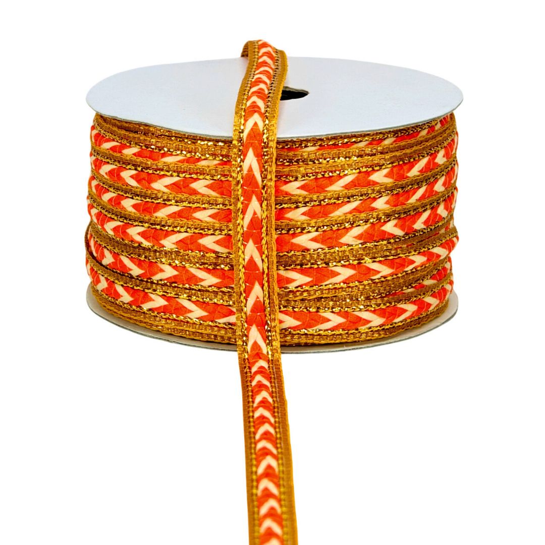 Spool of orange and white patterned ribbon on a white background