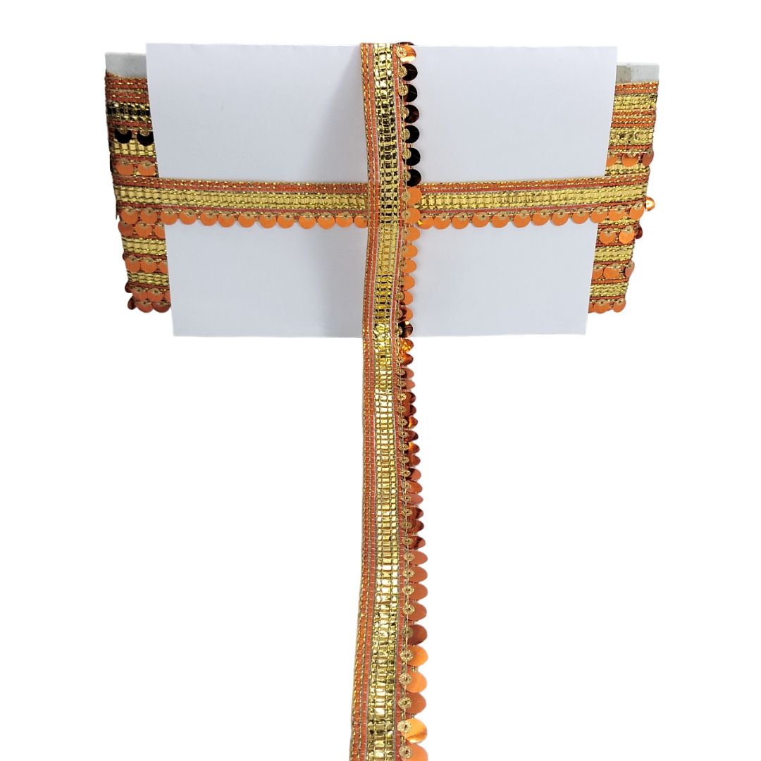 Decorative ribbon with gold and orange patterns on a white background
