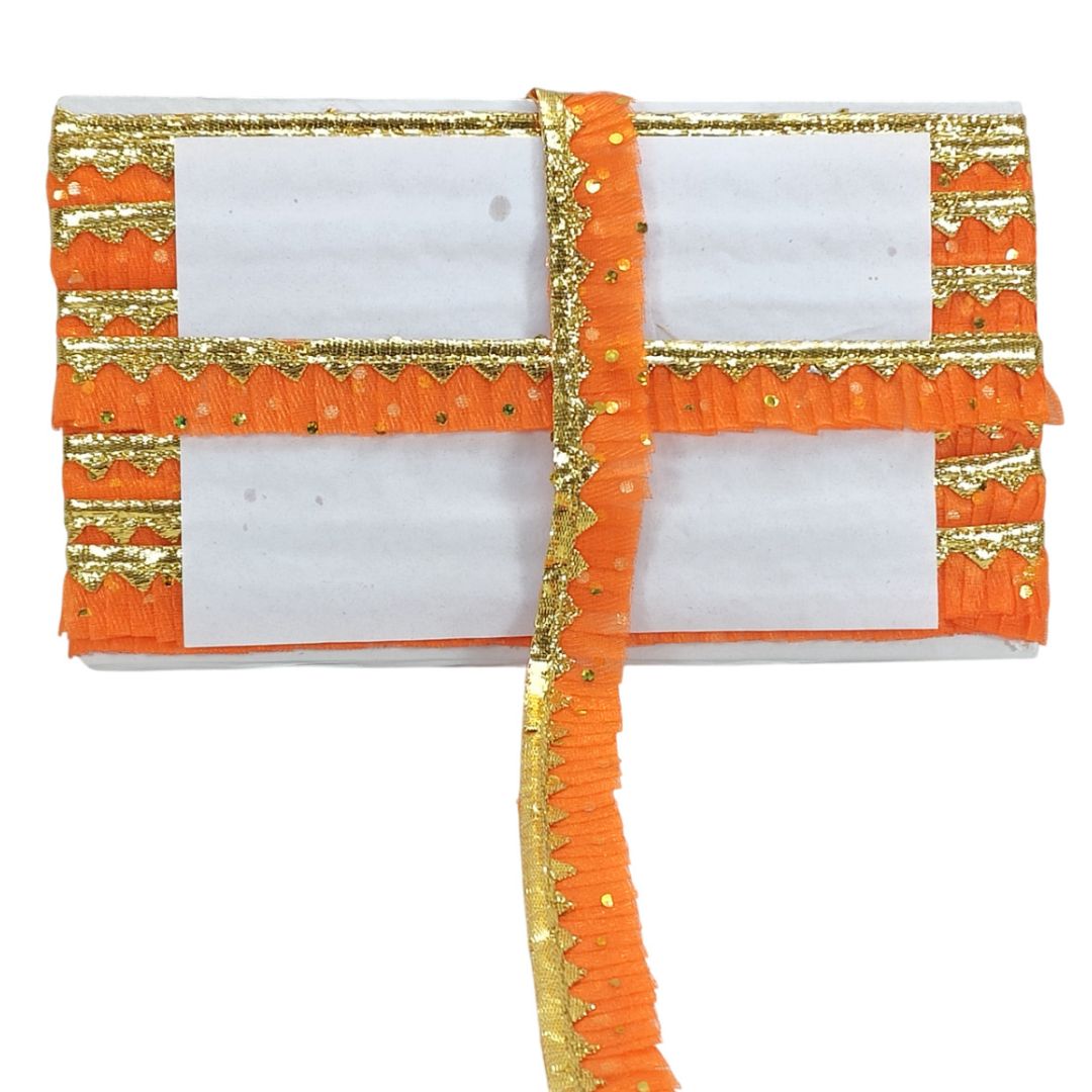 Orange and gold decorative fabric with white center on a white background