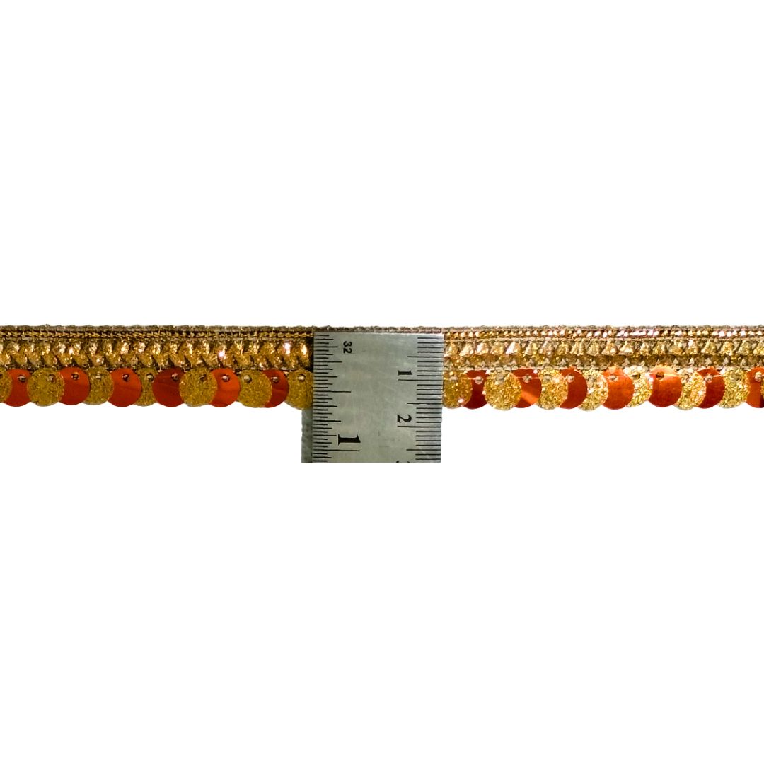 Gold and orange beaded trim with a ruler for scale on a white background