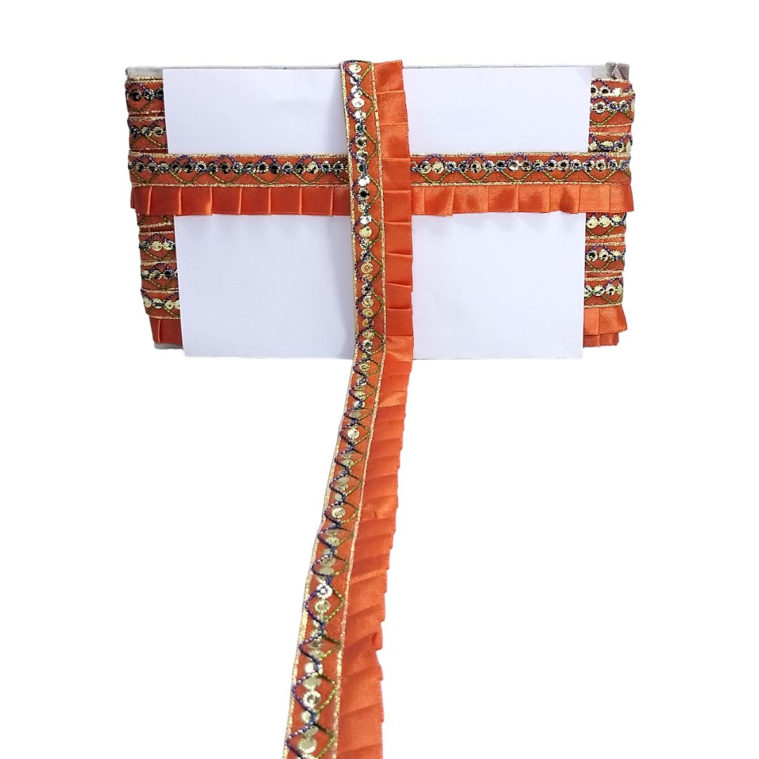 Traditional saree with orange and white design on a white background