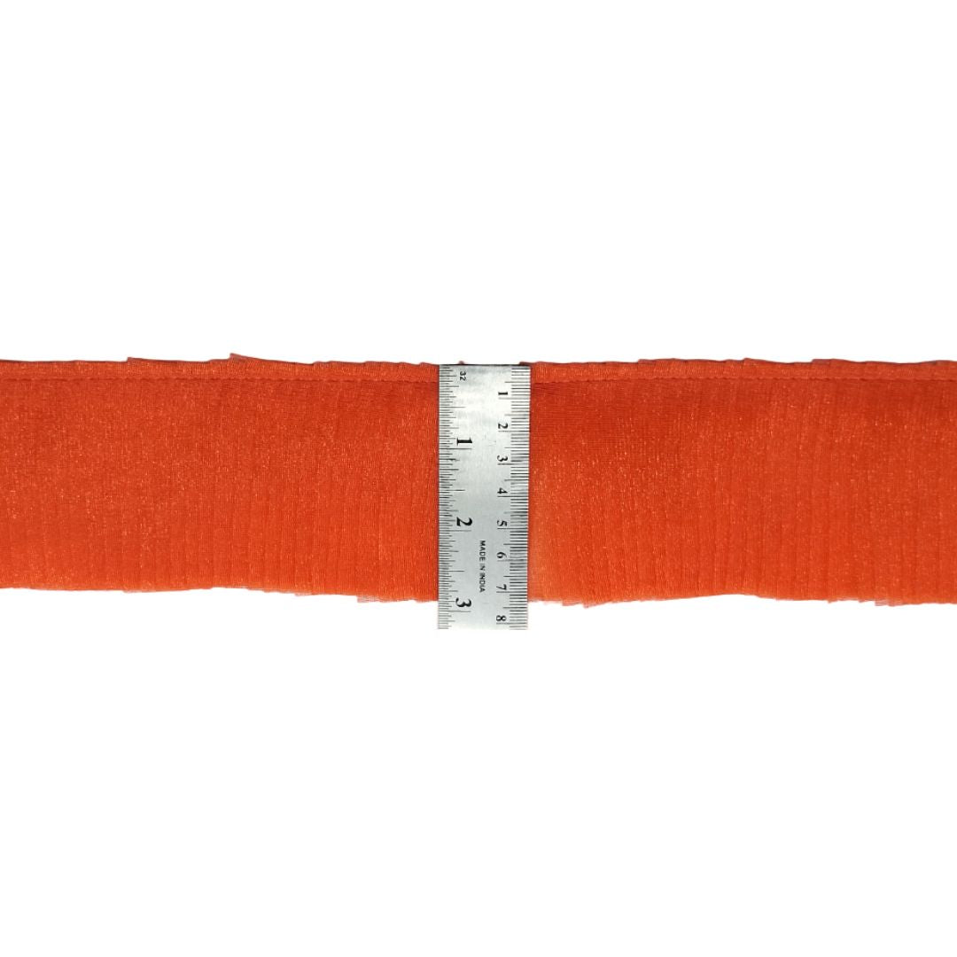 Orange ribbon with a ruler for measurement on a white background