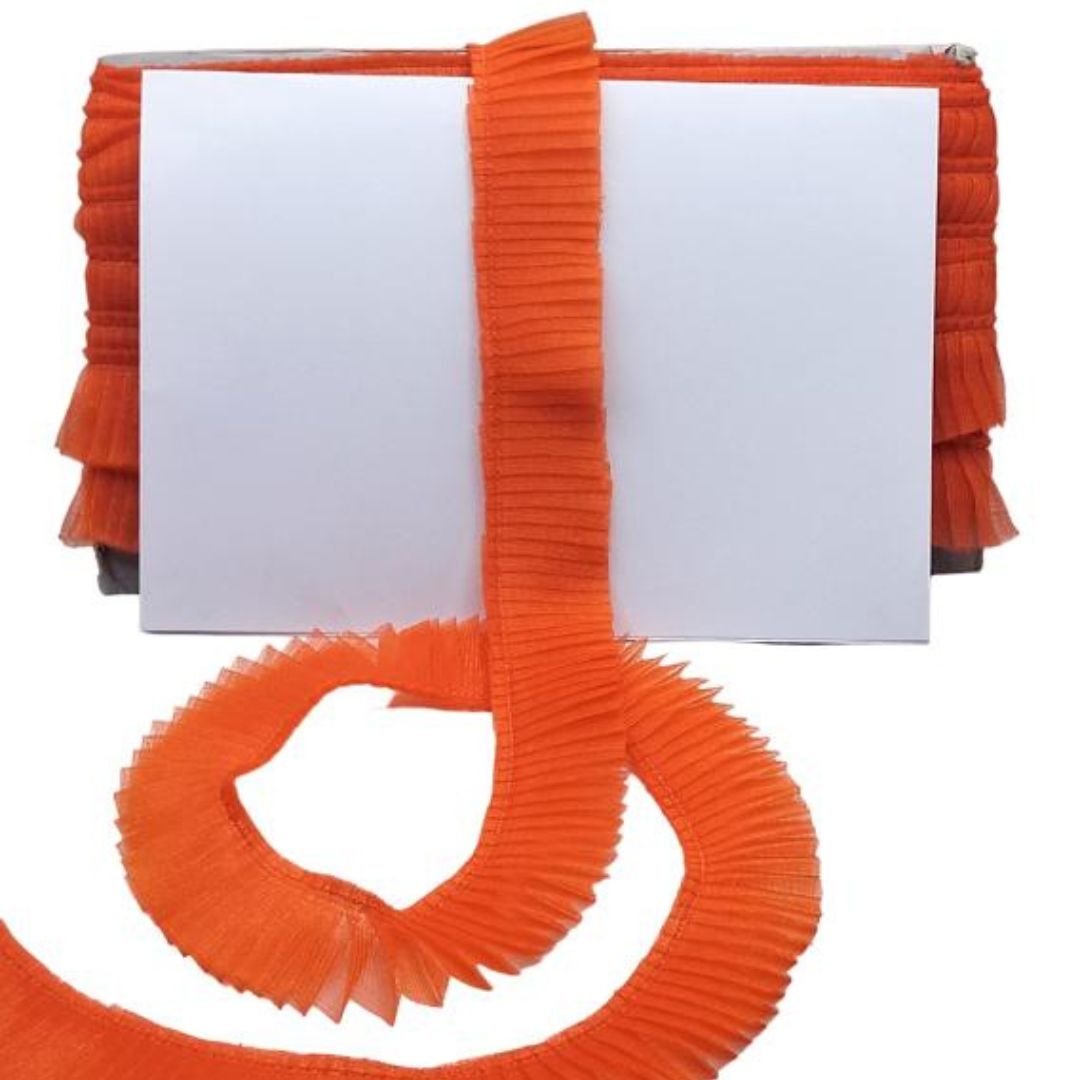 Orange pleated belt with a white background