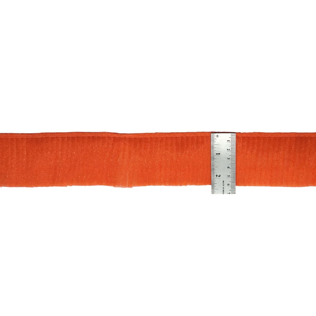 Orange fabric with a ruler for scale on a white background
