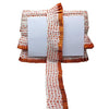 Orange and white patterned fabric on a white background