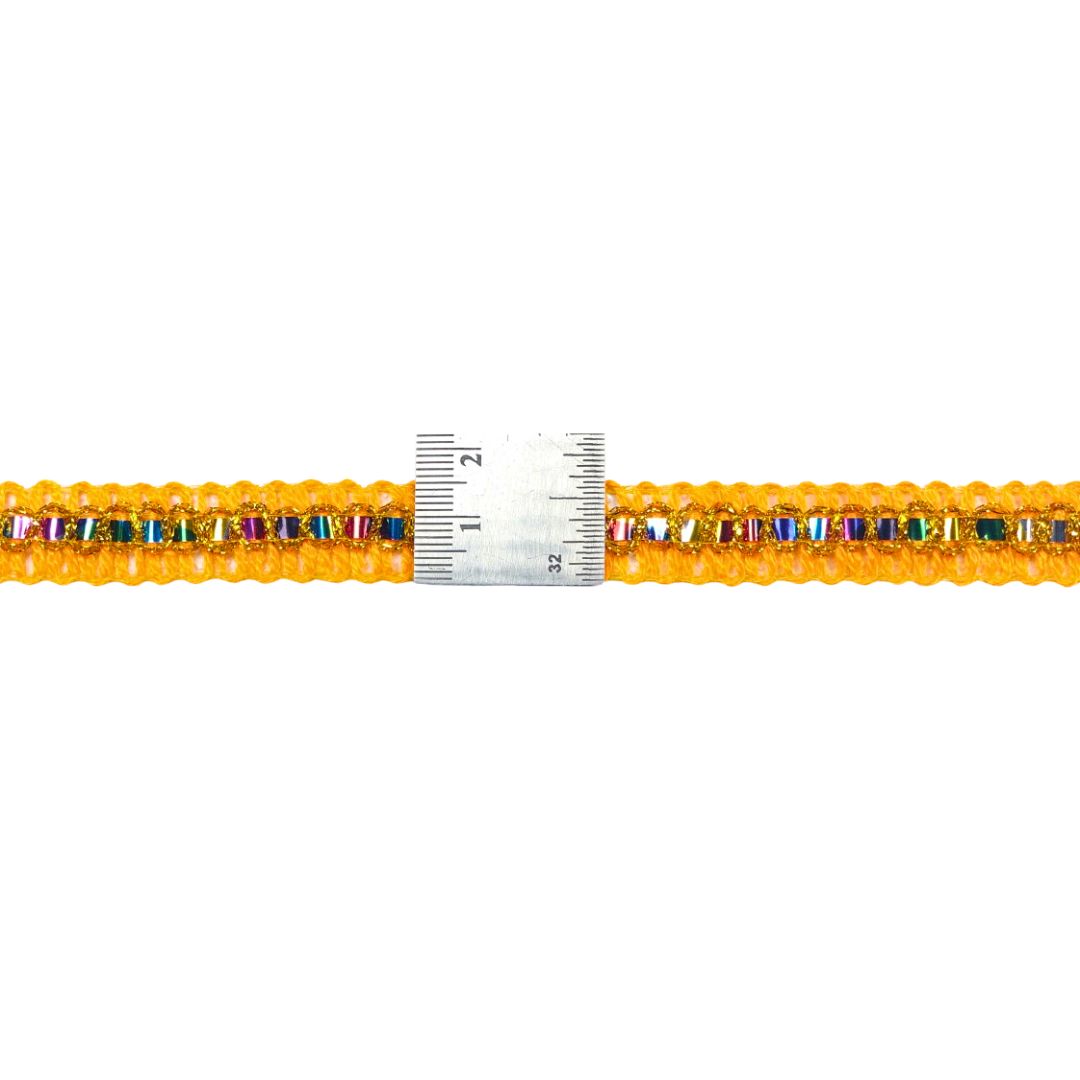 Multicolored beaded bracelet with a ruler for scale on a white background