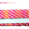 Folded fabric with pink and orange pattern on a white background