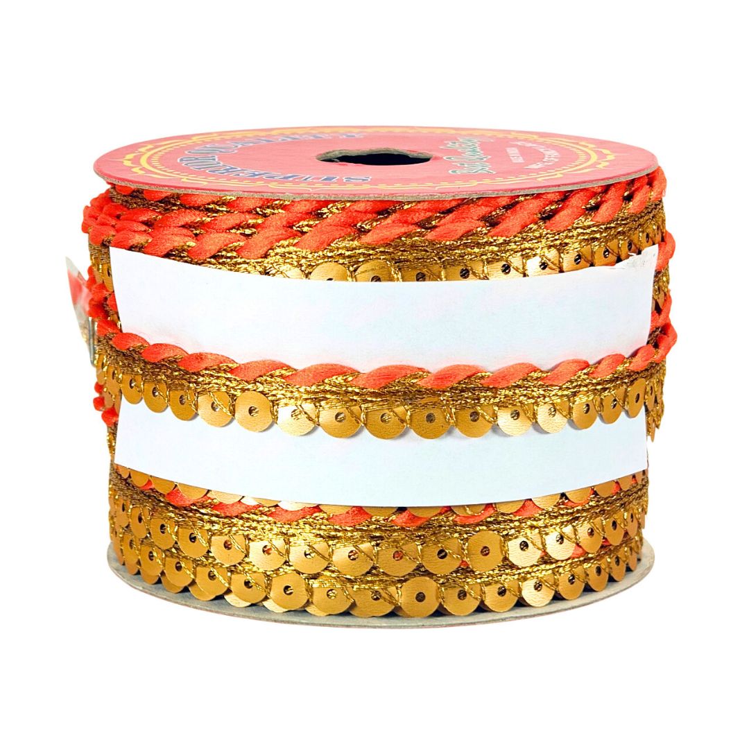 Spool of red and gold decorative ribbon with sequins on a white background