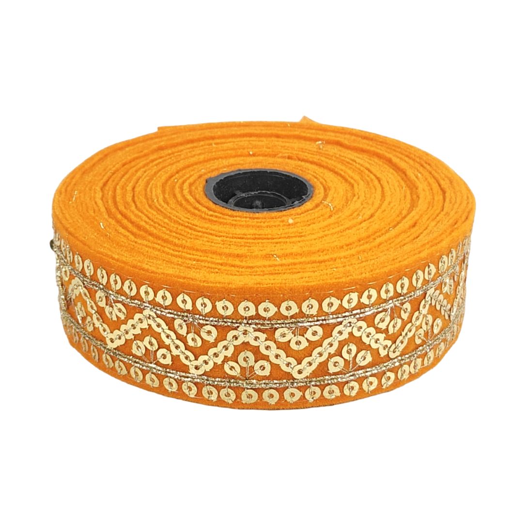 Orange ribbon with gold sequin trim on a white background