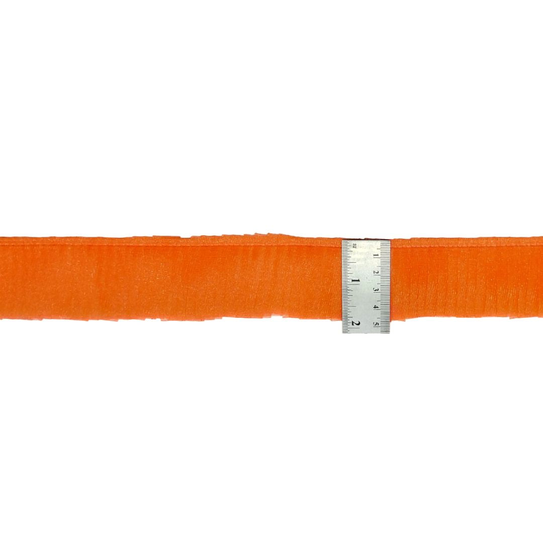 Orange belt with a ruler for size reference on a white background