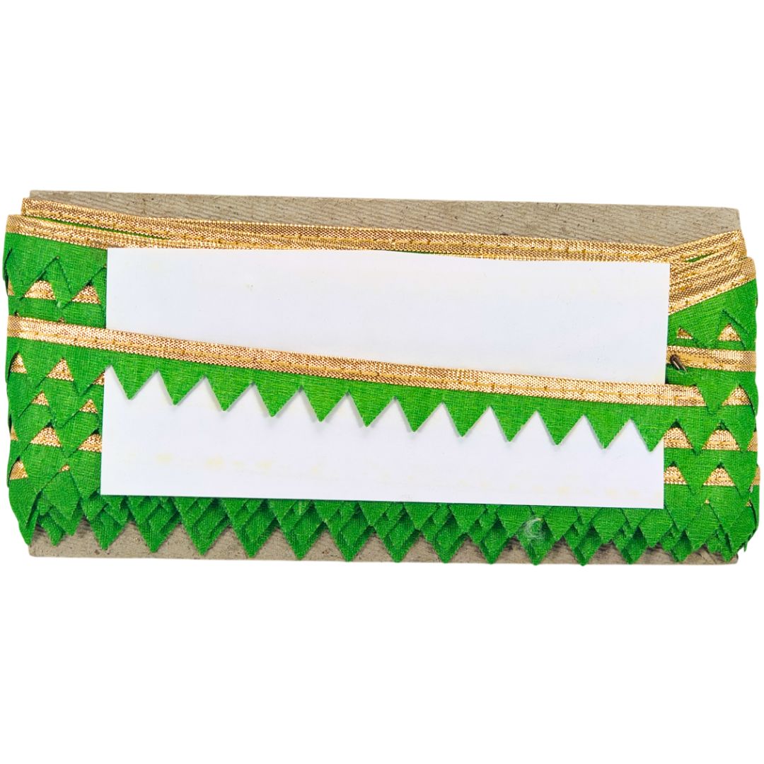 Green and gold decorative box with a white label on a white background