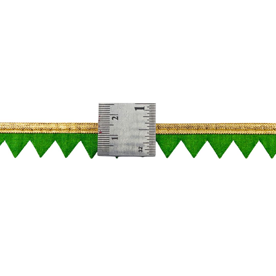 Green and gold decorative border with a ruler for scale on a white background