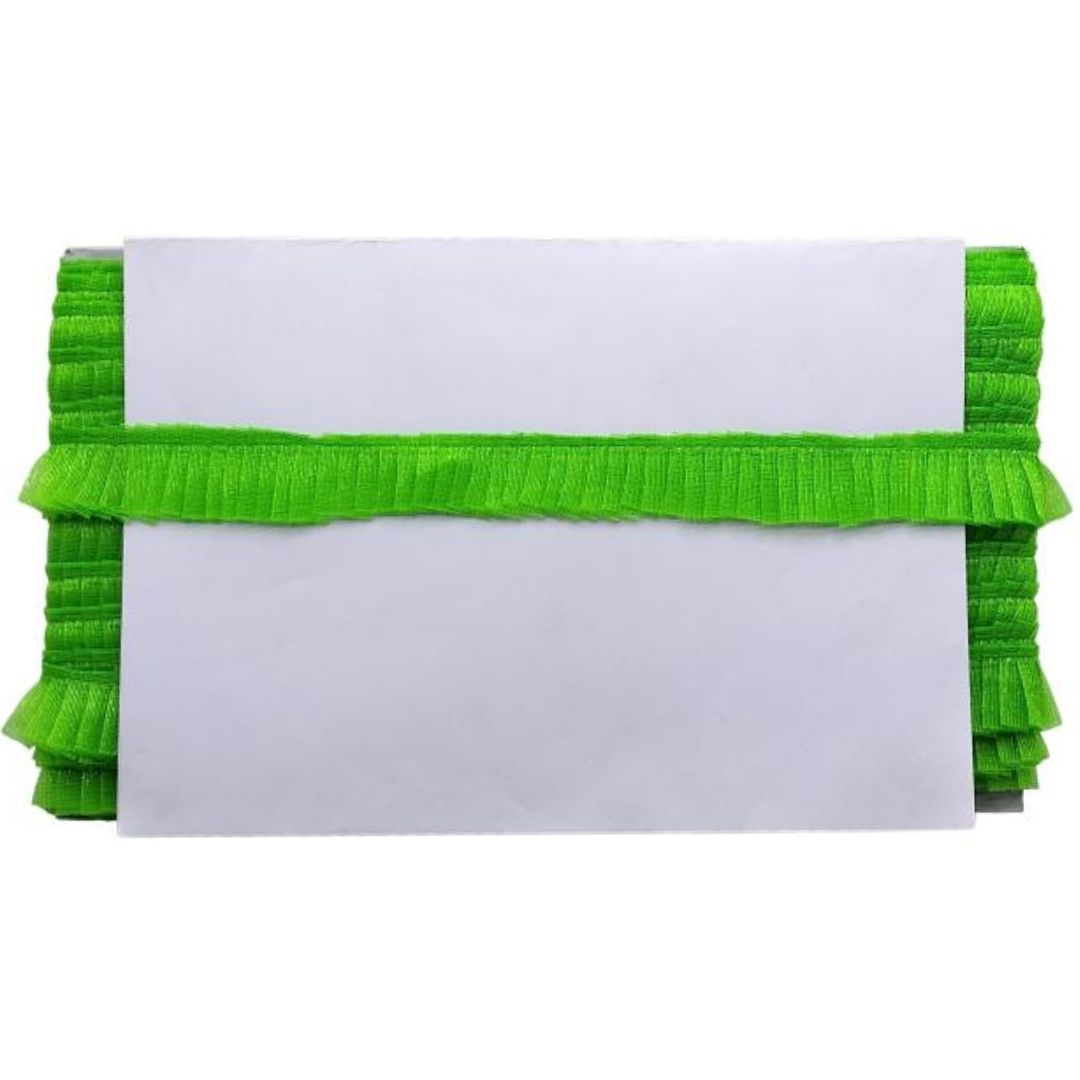 White envelopes with green ribbons stacked on a white background