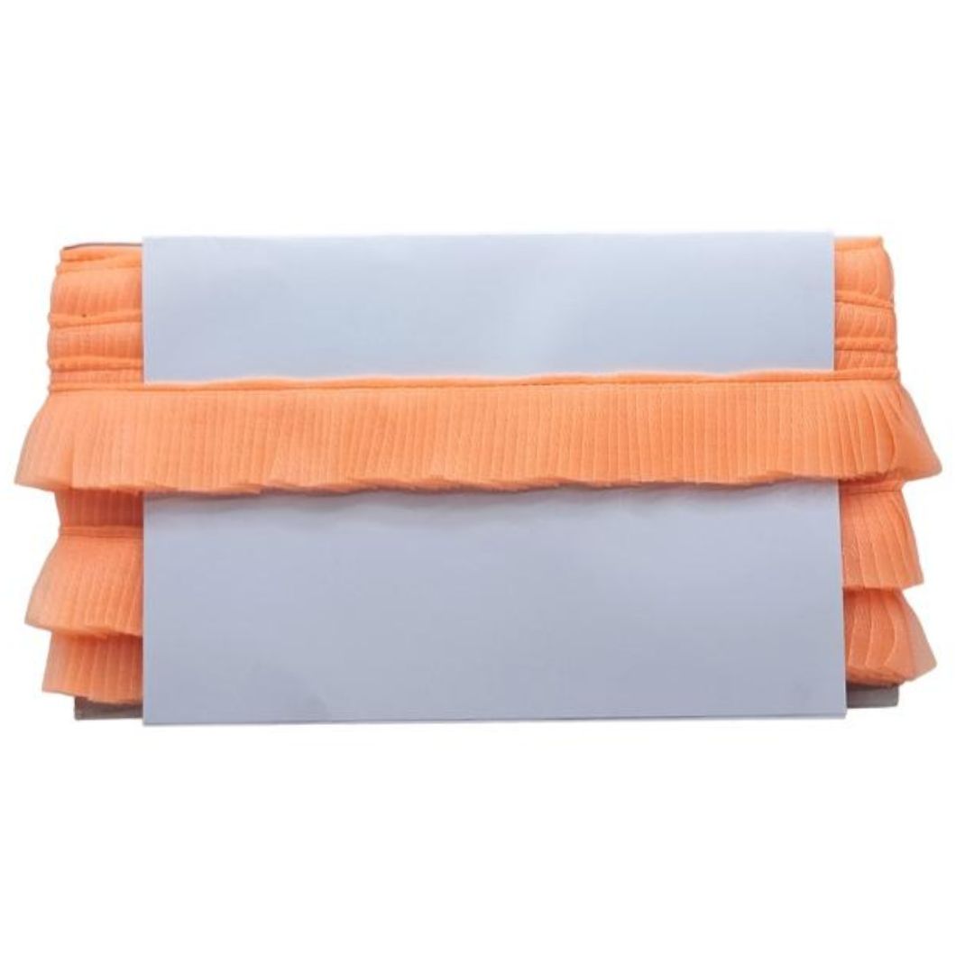 Orange clutch bag with ruffled layers on a white background