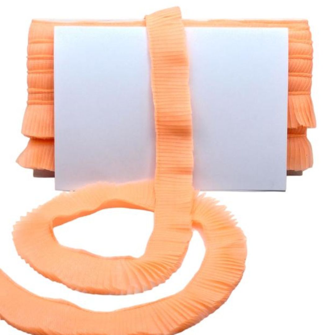 Orange ribbed belt with a long strap on a white background