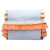 Decorative table cover with orange ruffles and gold trim on a white background