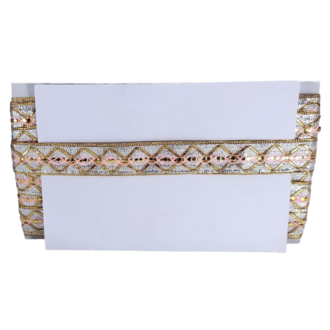 Decorative envelope with gold and pink pattern on a white background