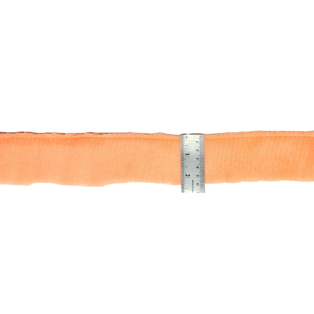 Orange ribbon with a ruler for measurement on a white background