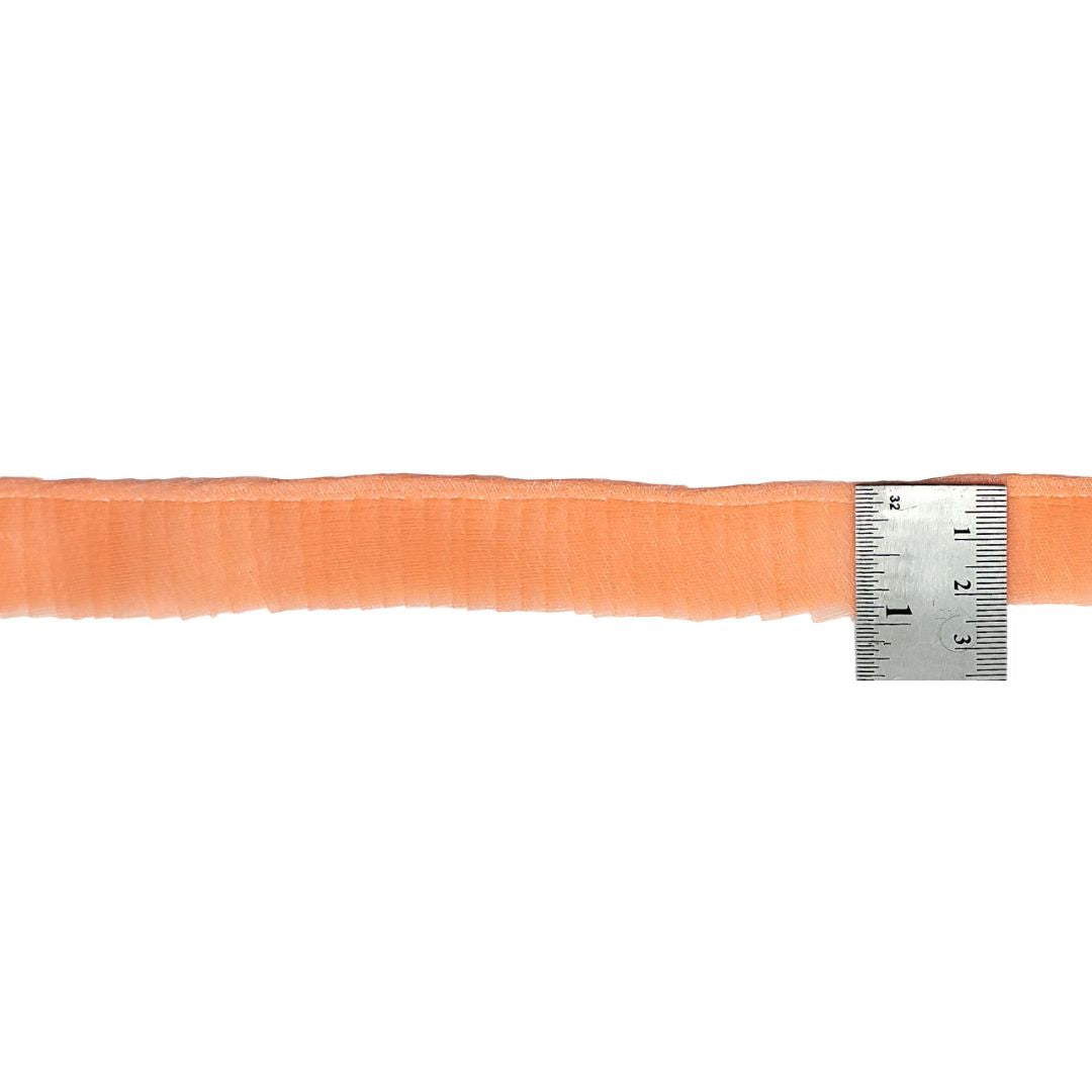 Orange ribbon with a ruler for measurement on a white background
