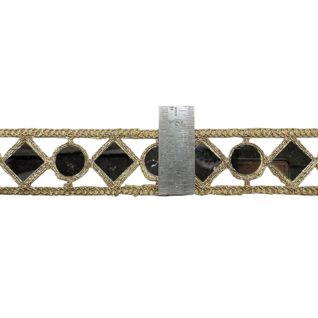 Decorative ribbon with black gemstones and gold accents, measured against a ruler on a white background.