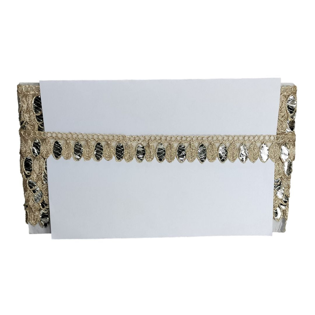White clutch with gold lace detailing on a white background
