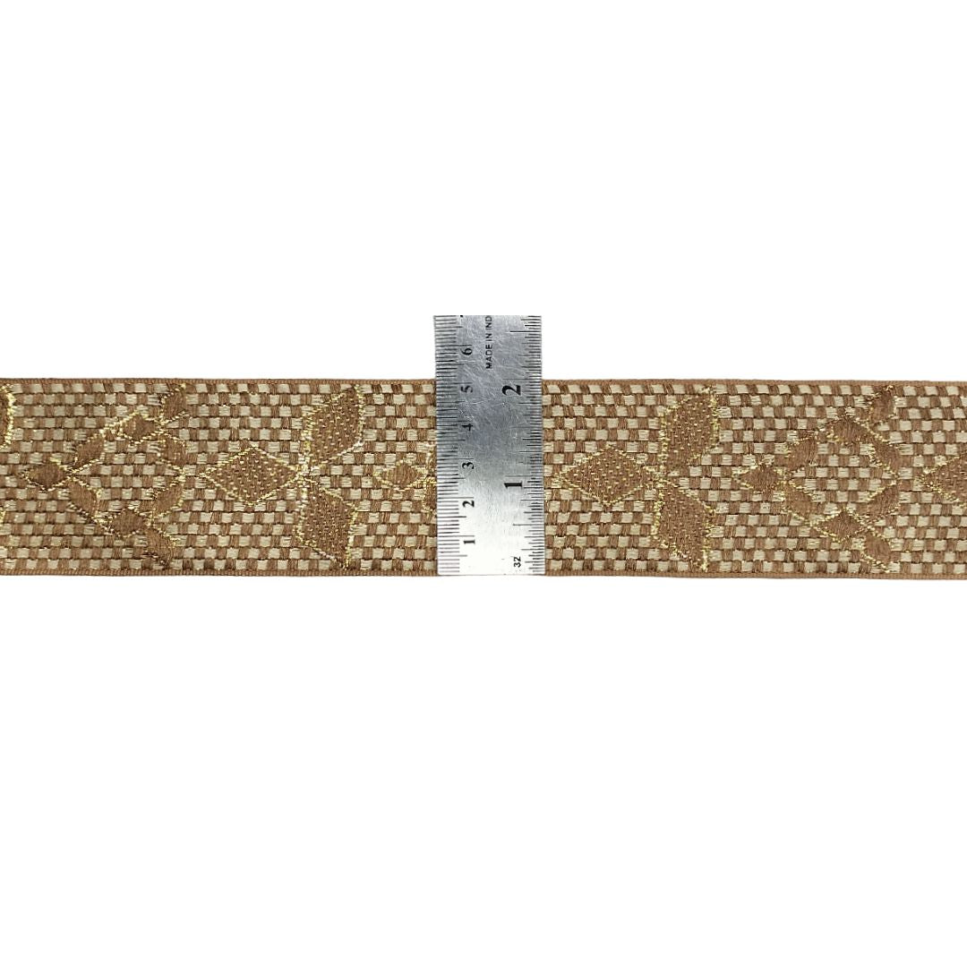 Beige fabric with floral pattern and a ruler for scale on a white background