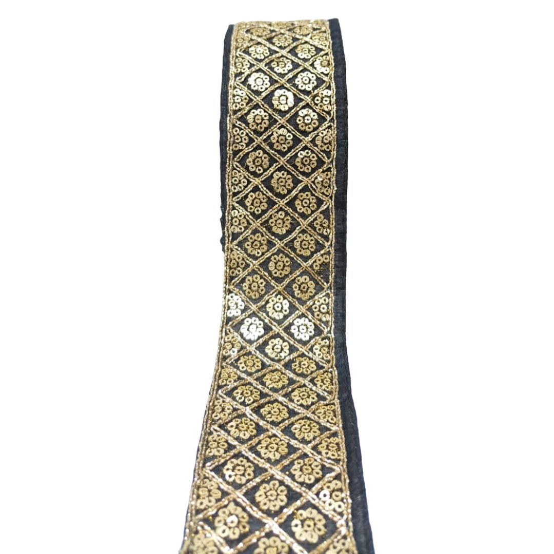 Decorative ribbon with gold and black pattern on a white background
