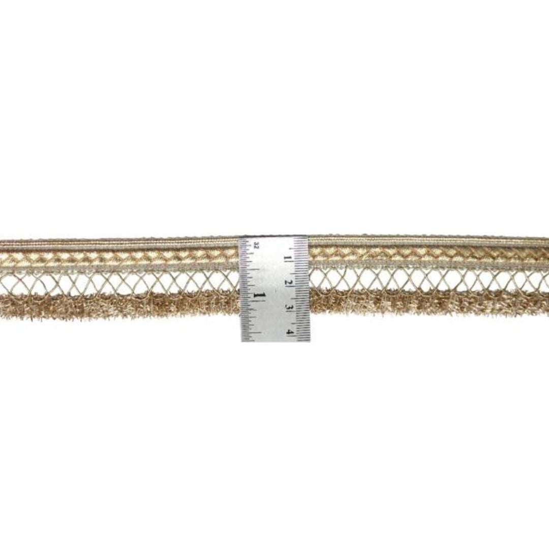 Gold metallic lace trim with a ruler for scale on a white background