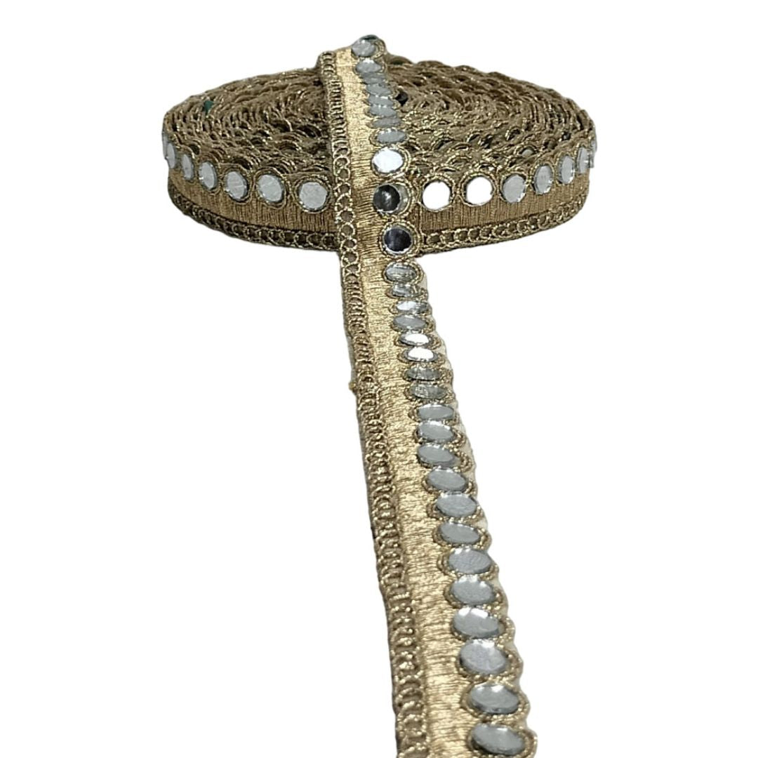 Decorative headband with gold lace and reflective stones on a white background