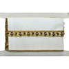 White clutch bag with gold decorative trim on a white background