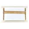 Decorative shelf with marble base and top, gold braided trim in the middle.