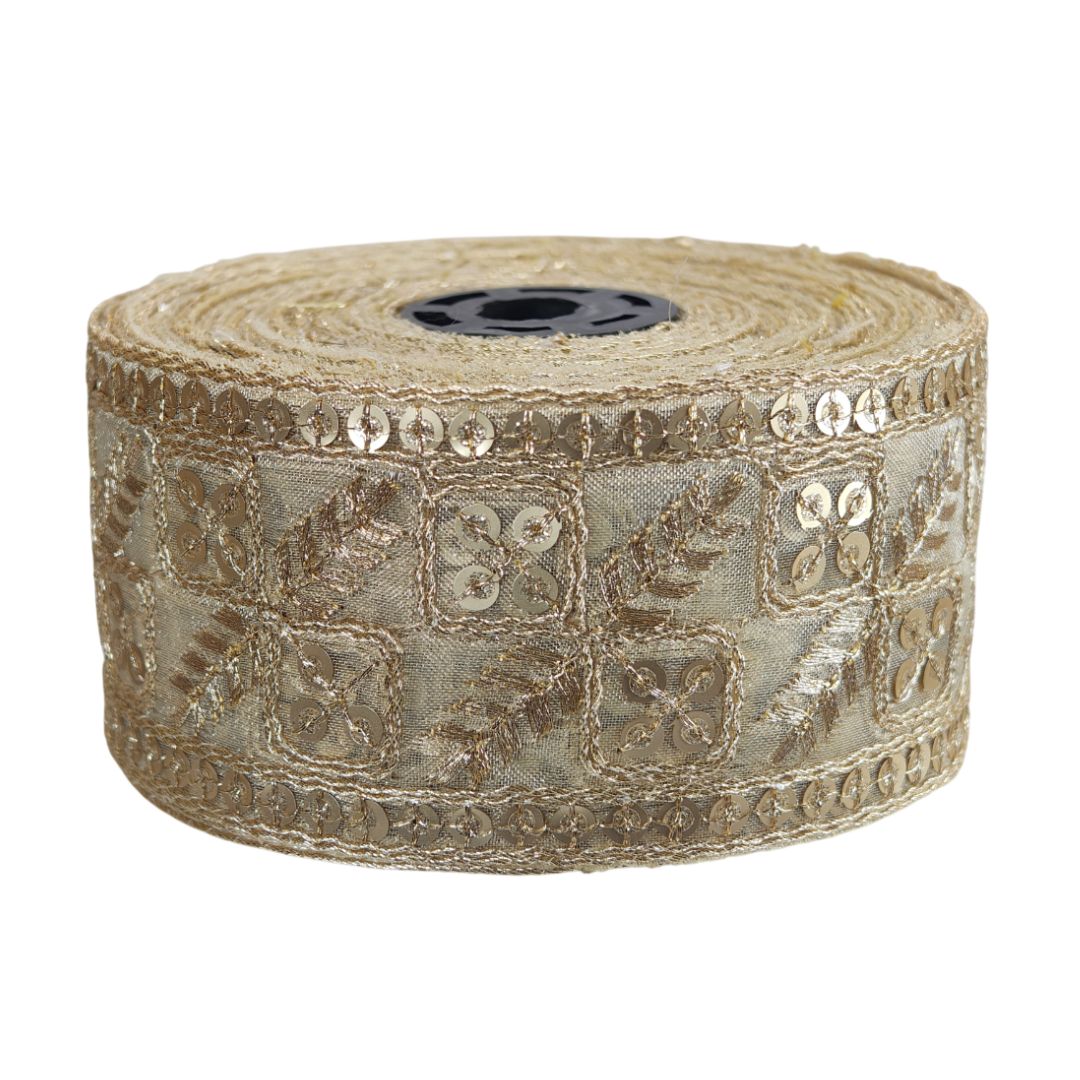 Roll of decorative ribbon with intricate patterns on a white background