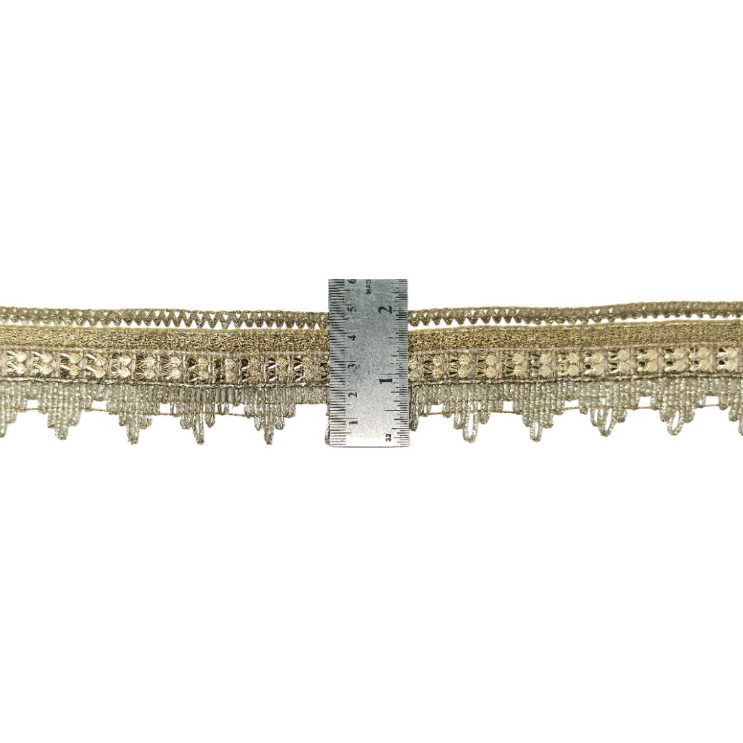 Decorative trim with a ruler for scale on a white background