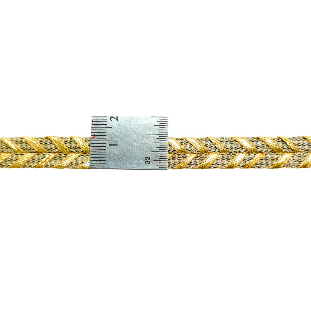 Gold braided cord with a measuring tape showing its width on a white background