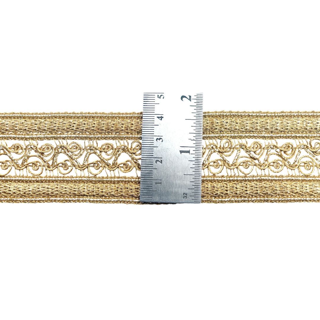 Gold lace trim with a ruler for measurement on a white background
