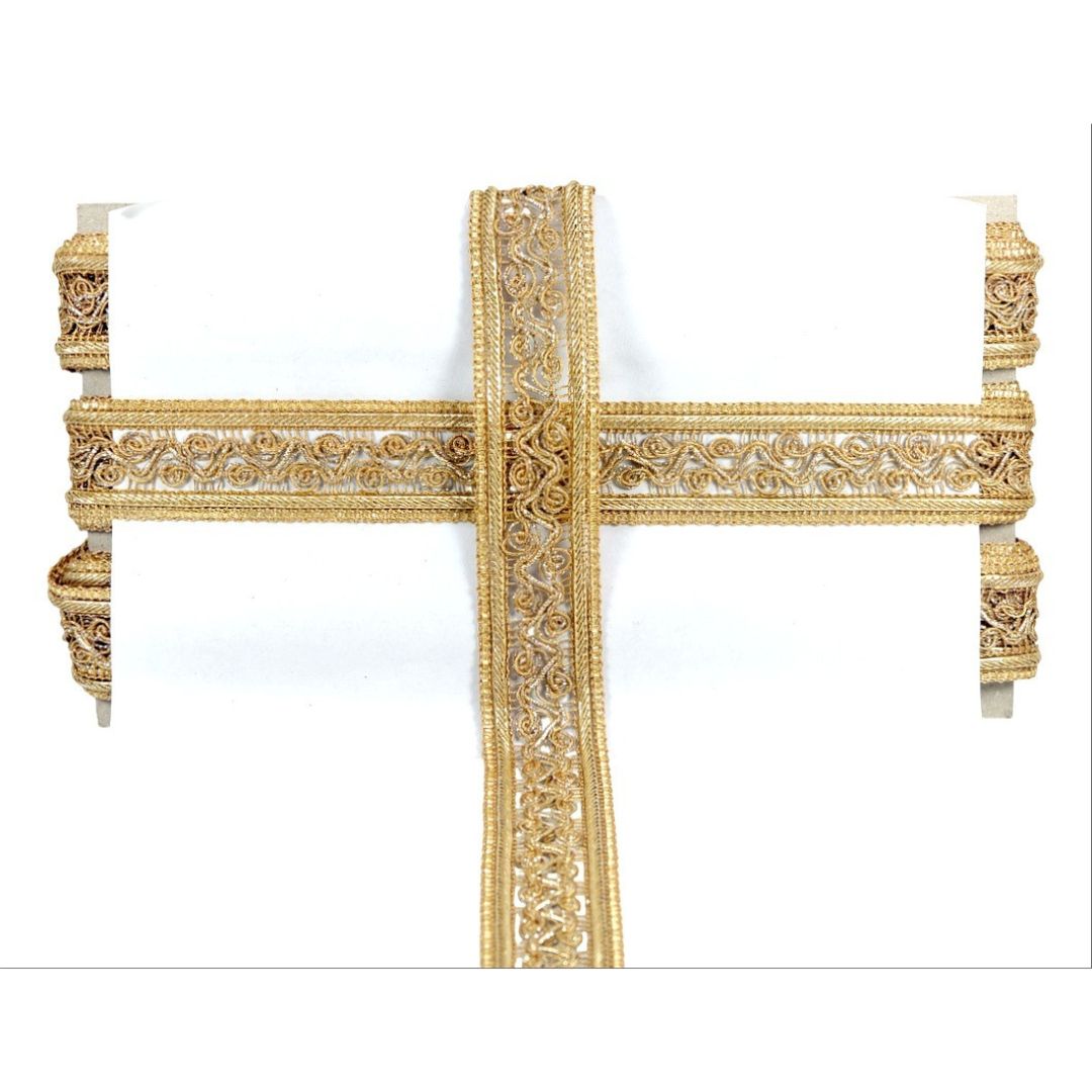Decorative gold cross on a white background