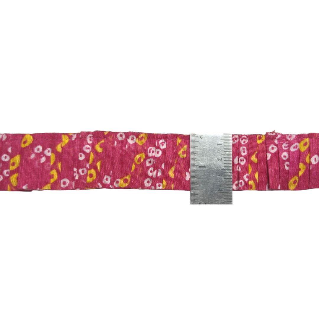 Floral-patterned belt with a ruler for size reference on a white background