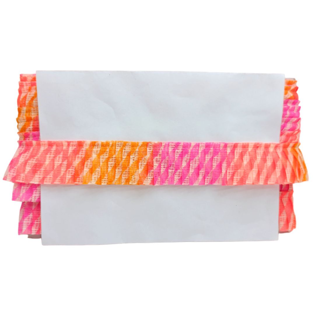 Neon pink and orange ruffled clutch on a white background