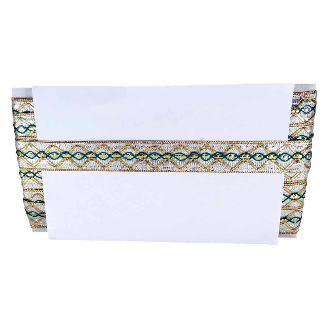 White towel with a decorative gold and blue border on a white background