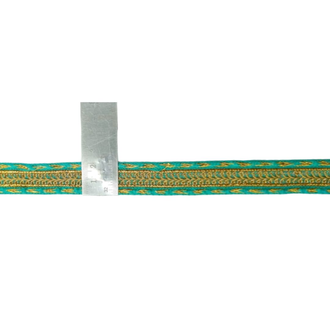 Teal and gold braided cord with a ruler for scale on a white background