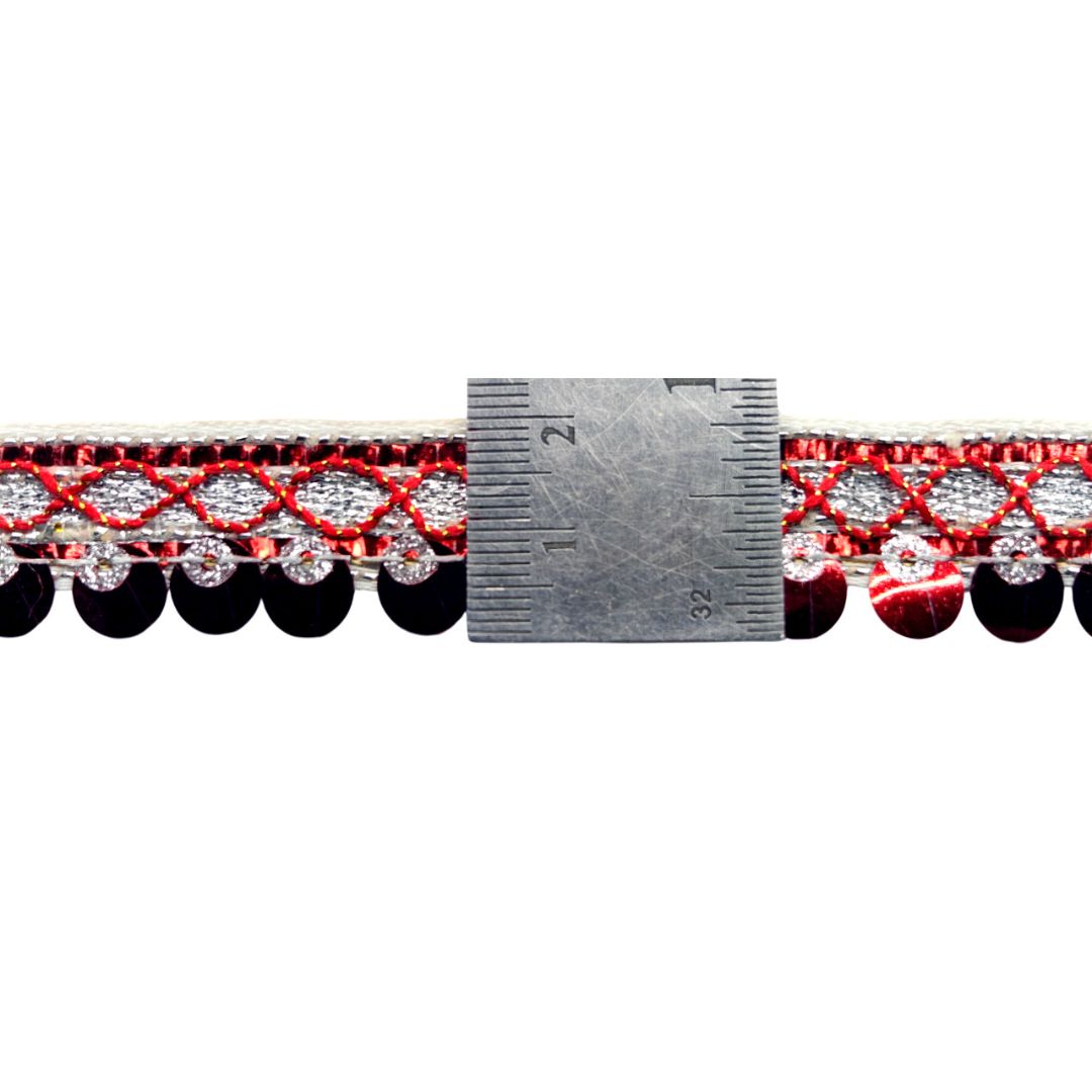 Red and black beaded trim with a measuring ruler on a white background
