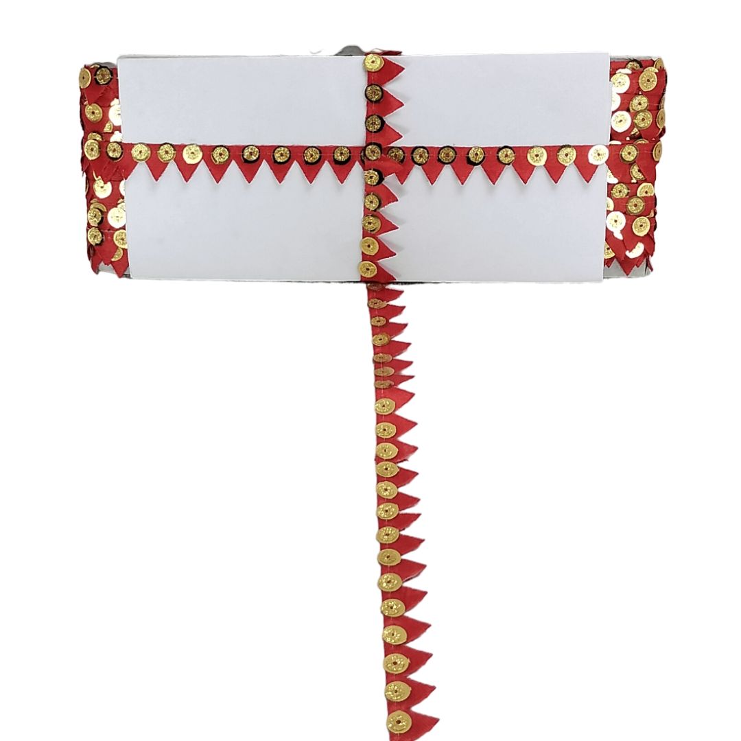White clutch with red and gold decorative accents on a white background