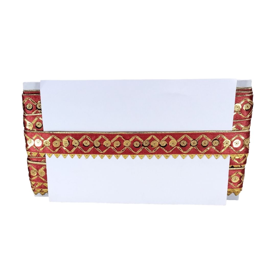 White napkin with red and gold decorative border on a white background