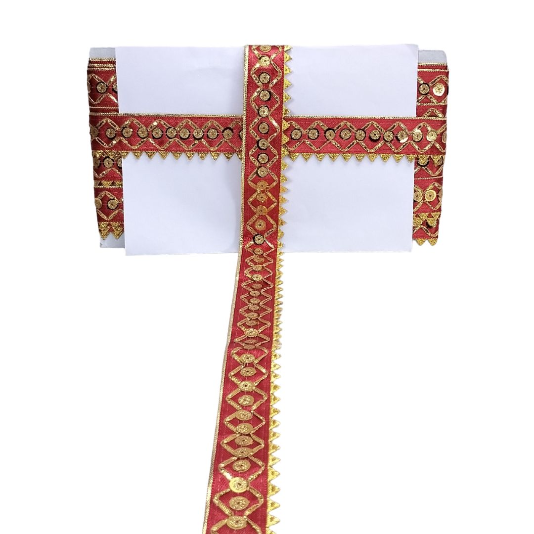 White tablecloth with red and gold decorative border on a white background