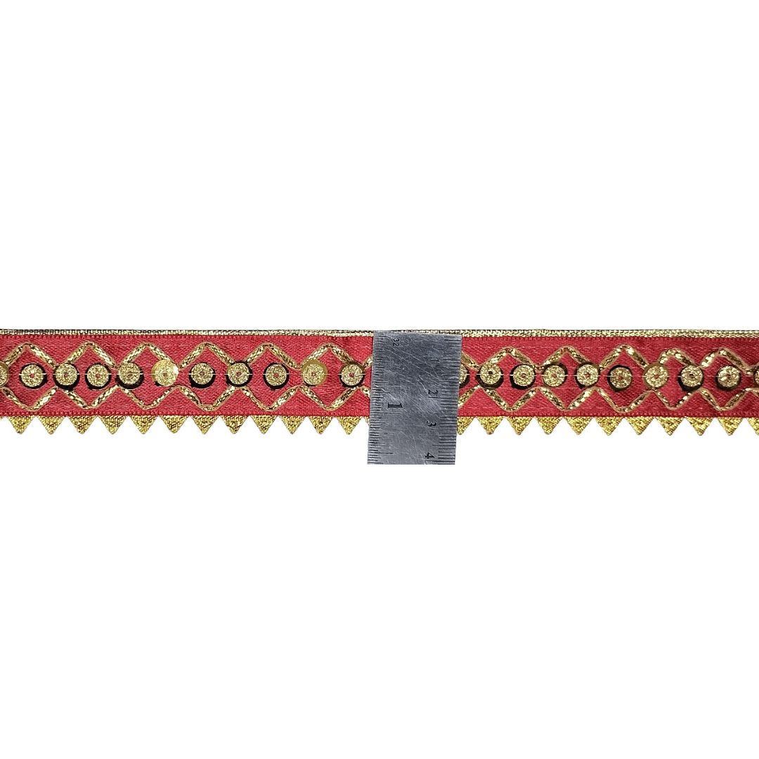 Decorative red ribbon with gold patterns on a white background