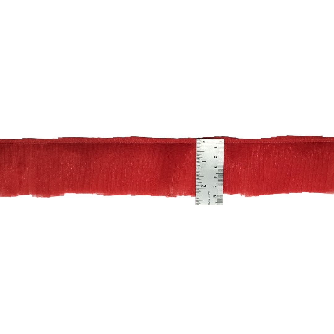 Red belt with a ruler for size reference on a white background