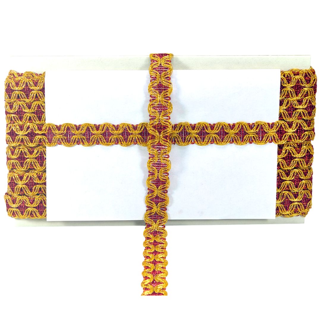 Decorative cross with yellow and red pattern on a white background