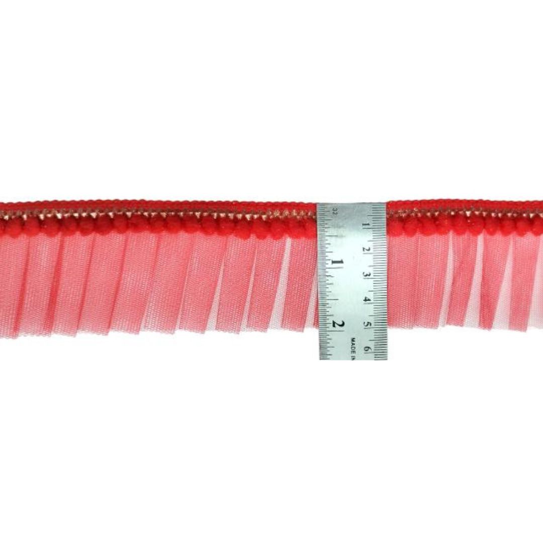 Red fringe trim with a ruler for measurement on a white background