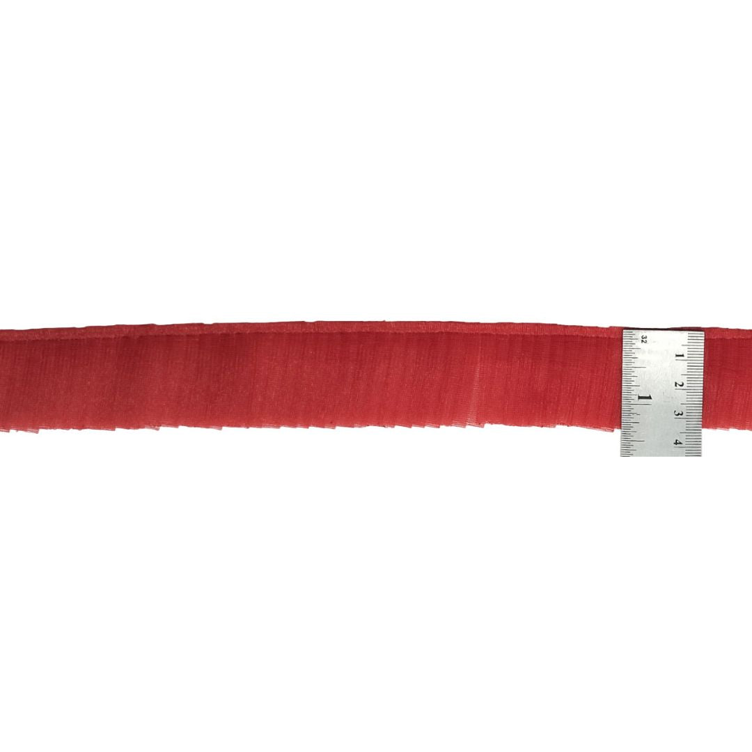 Red fabric strip with a ruler for measurement on a white background
